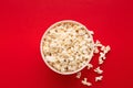 Bucket of popcorn on red background, top view Royalty Free Stock Photo