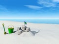 Bucket, spade and sand castle on a beach.