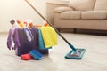 Bucket with sponges, chemicals bottles and mopping stick. Royalty Free Stock Photo