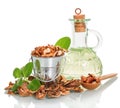 Bucket, spoon with shelled walnuts, oil bottle and shell isolated. Royalty Free Stock Photo