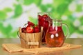 Bucket strawberries, glass, jug with drink, wipes on abstract green .