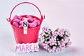 Bucket with sweets and flowers.