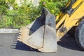 Bucket with tines from the tractor on a summer day on the pavement in the city, parked on the side of the road. working equipment Royalty Free Stock Photo