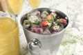 Bucket of water with floral ice cubes and champagne bottle Royalty Free Stock Photo