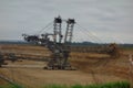 bucket-wheel excavator at a brown coal lignite opencast mining. Fossil fuels in Garzweiler, germany. Landscape with a lot of dirt Royalty Free Stock Photo