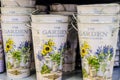 Empty bucket with vintage floral decorations on white background.