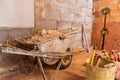 Buckets full of tools and a wheelbarrow full of pieces of plaster Royalty Free Stock Photo