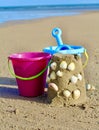 Buckets and spade with sand pie and shells Royalty Free Stock Photo