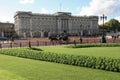 Buckingham Palace London. Horse drawn Brougham carriage being ridden in front of the gates.