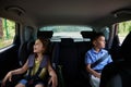 Buckled children, boy and girl, traveling in a safety booster seat inside the car. Safe travel with children in the car