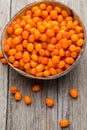 Buckthorn berry basket on wooden background. Royalty Free Stock Photo