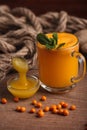 Buckthorn juice in a glass with honey Royalty Free Stock Photo