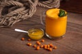 Buckthorn juice in a glass with honey Royalty Free Stock Photo