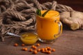 Buckthorn juice in a glass with honey Royalty Free Stock Photo