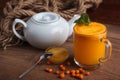 Buckthorn juice in a glass with honey Royalty Free Stock Photo