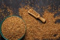 Buckwheat brown in a bowl on a black wooden background. Close-up. View from above.