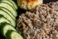 Buckwheat cereal with grilled chicken cutlet and slised cucumber Royalty Free Stock Photo