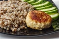 Buckwheat cereal with grilled chicken cutlet and slised cucumber Royalty Free Stock Photo