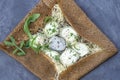 Buckwheat crepe with goat cheese and fresh arugula leaves on grey stone background Royalty Free Stock Photo