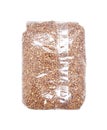 Buckwheat groats in a transparent bag isolated on a white background.