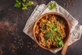 Buckwheat with meat in a wooden bowl on a dark background, top v