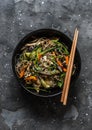 Buckwheat noodles with chicken breast, vegetables and mushrooms - delicious asian style lunch on a dark background, top view Royalty Free Stock Photo