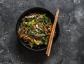 Buckwheat noodles with chicken breast, vegetables and mushrooms - delicious asian style lunch on a dark background, top view Royalty Free Stock Photo