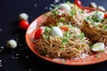 Buckwheat noodles with quail eggs, tomatoes and microgreen. Selective focus Royalty Free Stock Photo