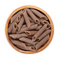 Buckwheat penne, gluten free whole grain pasta, in a wooden bowl