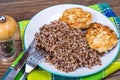 Buckwheat porridge with cutlets on white plate Royalty Free Stock Photo