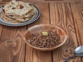 Buckwheat porridge in a deep plate and a stack of freshly baked tortillas on a wooden table Royalty Free Stock Photo