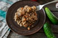 Buckwheat porridge on a fork, close-up A plate of buckwheat porridge with carrots and meat. Fork, cucumber, tomato Royalty Free Stock Photo