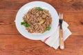 Buckwheat porridge with fried mushrooms on dish, fork on napkin Royalty Free Stock Photo