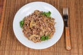 Buckwheat porridge with fried mushrooms and onions on dish, fork Royalty Free Stock Photo