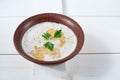 Buckwheat porridge with milk, butter, and fresh parsley in a deep bowl