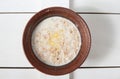 Buckwheat porridge with milk, butter, and fresh parsley in a deep bowl