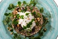 Buckwheat porridge with poached egg and fried mushrooms, decorated with celery.