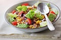 Buckwheat porridge with vegetables, onion, lettuce, tomato, horn in a bowl on white background