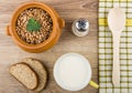 Buckwheat in pot, cup of milk, bread, salt, wooden spoon Royalty Free Stock Photo