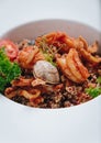 buckwheat with seafood, oyster, tomato and herbs in a deep plate side view Royalty Free Stock Photo