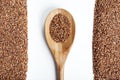 Buckwheat and spoon on a white background.