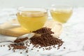 Buckwheat tea and granules on white marble table