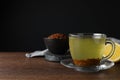 Buckwheat tea and granules on wooden table, space for text