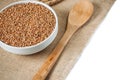 Buckwheat and wooden spoon on burlap background. isolate