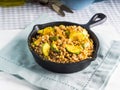 Buckwheat with zucchini and turmeric in skillet