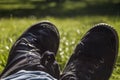 Bucolic black urban trainers over green grass background