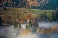 Bucovina autumn sunrise landscape in Romania with mist and mountains