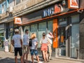 Bucuresti/Romania - 08.18.2020: People waiting in line in front of a ING Bank branch respecting the social distancing to prevent