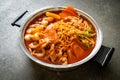 Budae Jjigae or Budaejjigae Army stew or Army base stew. It is loaded with Kimchi, spam, sausages, ramen noodles and much more