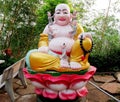 Budai sitting in lotos colorful statue Royalty Free Stock Photo